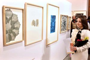 A visitor viewing the displayed art stuff during exhibition of Degree Show at NCA