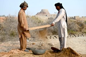 Labourers busy in cleaning the soil during excavation work under the supervision of American archaeologist Prof. Dr. Jonathan Mark Kenoyer at world famous archeological site of Mohen jo-Daro