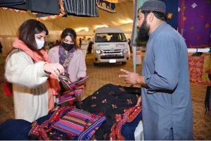 An artisan creating a piece of string art during International Tourism Conference & Exhibition Pakistan 2026 at a local hotel.