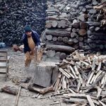 A man cutting wood into pieces for selling purpose at his workplace in the Provincial Capital