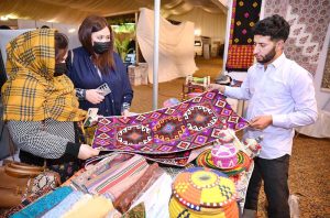 An artisan creating a piece of string art during International Tourism Conference & Exhibition Pakistan 2026 at a local hotel.
