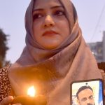 Members of the Human Rights Council of Pakistan light earthen oil lamps during a vigil outside the Karachi Press Club to pay tribute to the victims of the Gul Plaza fire, which claimed more than 60 lives, while dozens of people are still feared trapped under the debris as rescue operations continue