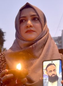 Members of the Human Rights Council of Pakistan light earthen oil lamps during a vigil outside the Karachi Press Club to pay tribute to the victims of the Gul Plaza fire, which claimed more than 60 lives, while dozens of people are still feared trapped under the debris as rescue operations continue