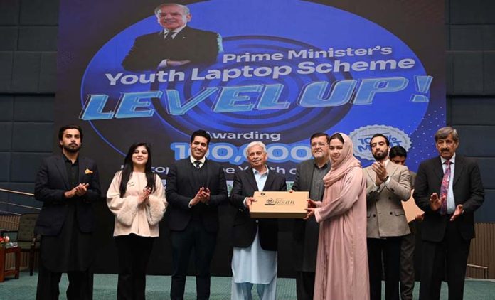 Federal Minister for Industries and Production Rana Tanveer Hussain and University of Sargodha Vice Chancellor Prof. Dr. Qaiser Abbas distribute laptops to students during the Prime Minister Laptop Scheme Regional Distribution Ceremony at the University of Sargodha