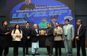 Federal Minister for Industries and Production Rana Tanveer Hussain and University of Sargodha Vice Chancellor Prof. Dr. Qaiser Abbas distribute laptops to students during the Prime Minister Laptop Scheme Regional Distribution Ceremony at the University of Sargodha