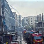 Firefighters douse water to extinguish fire at Gul Plaza.