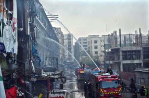 Firefighters douse water to extinguish fire at Gul Plaza.