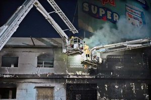 Firefighters douse water to extinguish fire at Gul Plaza.