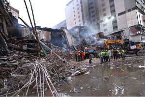 Firefighters douse water to extinguish fire at Gul Plaza.