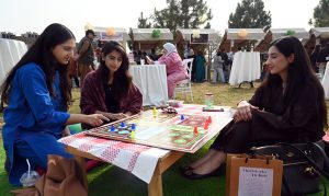 Young girls enjoy a game of ludo at the newly launched Community Market set up by the Capital Development Authority (CDA), aimed at promoting youth entrepreneurship and supporting local businesses amid the rising trend of informal pop-up markets in the Federal Capital
