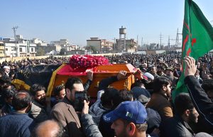 People gather to attend funeral prayers of victims following the suicide bombing at a religious site on the outskirts of the federal capital. Thousands of mourners, including federal ministers, attended the mass funeral.