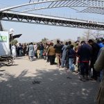 Motorcyclists wait in a queue for M-Tag installation at Kachnar Park after the Islamabad administration made M-Tag registration mandatory for all motorcycles from February 20, 2026, under the second phase of the capital’s vehicle tagging drive