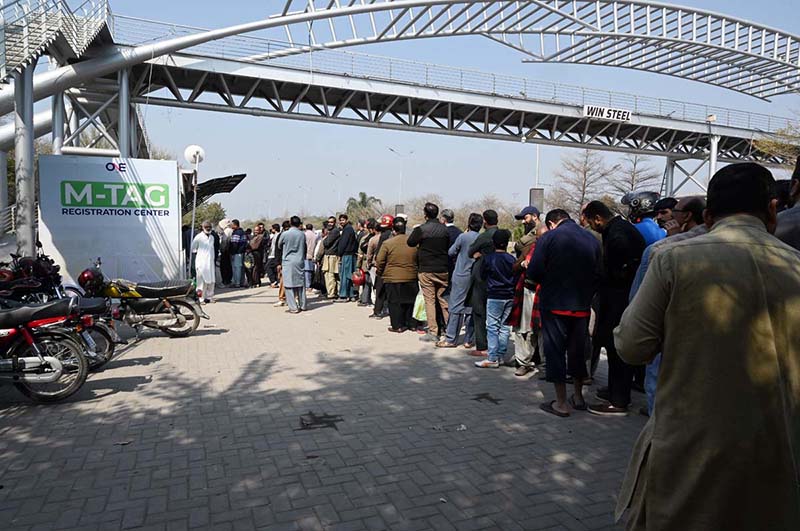 Motorcyclists wait in a queue for M-Tag installation at Kachnar Park after the Islamabad administration made M-Tag registration mandatory for all motorcycles from February 20, 2026, under the second phase of the capital’s vehicle tagging drive