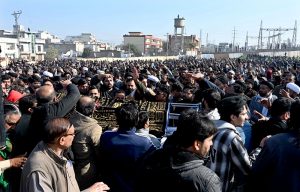 People gather to attend funeral prayers of victims following the suicide bombing at a religious site on the outskirts of the federal capital. Thousands of mourners, including federal ministers, attended the mass funeral.