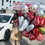 A vendor selling balloons to attract customers near Kuri road area in the city