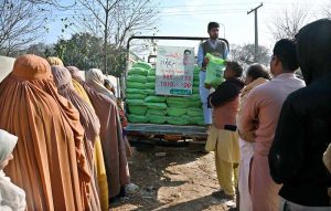 People are standing in a queue to purchase flour bags at a subsidized rate in the city.