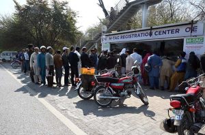 Motorcyclists wait in a queue for M-Tag installation at Kachnar Park after the Islamabad administration made M-Tag registration mandatory for all motorcycles from February 20, 2026, under the second phase of the capital’s vehicle tagging drive