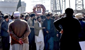 People gather to attend funeral prayers of victims following the suicide bombing at a religious site on the outskirts of the federal capital. Thousands of mourners, including federal ministers, attended the mass funeral.