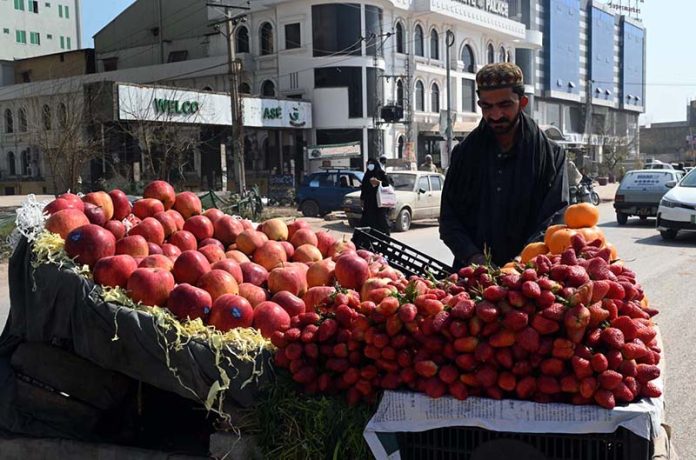 A vendor displaying fruits on his cart to attract customers at Ghori town in the Federal Capital