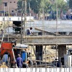 Workers busy in construction work of bridge over the Phulile Canal during development work in the city
