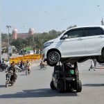 A traffic warden removing a wrongly parked car with the help of a forklift at Ghanta Ghar Chowk to ensure smooth flow of traffic in the City