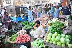 A buyer purchases seasonal vegetables at a local market as trading activity gains momentum ahead of the Holy month of Ramazan.