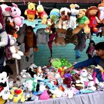 A vendor displaying and selling used toys on their handcart near Mayo Hospital in the Provincial Capital