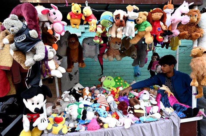 A vendor displaying and selling used toys on their handcart near Mayo Hospital in the Provincial Capital