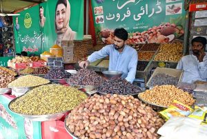 A vendor displaying dates to attract the customers at Model Bazaar.