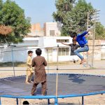 Children enjoying a fun-filled time as they jump and play on a trampoline set up in a neighborhood street area