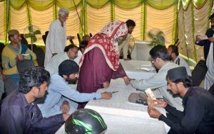 People are verifying their details and collecting cash under the Nigheban Ramazan Package at a Government Facilitation Center setup at Hockey Stadium.