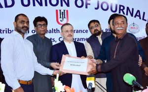 Sindh Minister for Information and Transport, Sharjeel Inam Memon, distributes health insurance cards to journalists during Phase-I of the Health Insurance Card distribution ceremony for working journalists, photojournalists, and cameramen, along with their families, organized by the Hyderabad Union of Journalists at the Press Club.