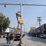Workers busy installing CCTV cameras under the Safe City Project Khyber Pakhtunkhwa at Khyber Bazar.