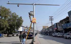 Workers busy installing CCTV cameras under the Safe City Project Khyber Pakhtunkhwa at Khyber Bazar.