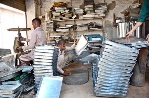 Workers are busy making bakery trays at a local workshop to meet the growing demand of bakeries.
