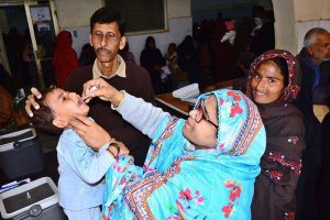 A health worker administers polio vaccine drops to a child during an anti-polio campaign at Government Bhitai Hospital.