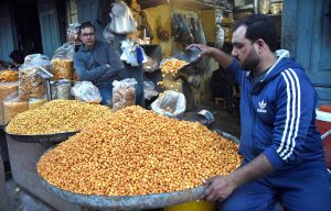 A shopkeeper displaying different items to attract the customers in connection with upcoming holy month of Ramzanul Mubarak.