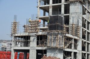 Labourers carry iron rods for the construction of a building at Park View City in the Federal Capital.