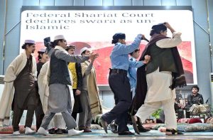A student performs on stage during the Singing Competition (Folk & Ghazal) at Islamabad Model College for Girls (PG), G-10/4.