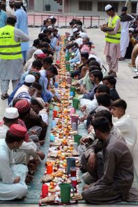A volunteer arranges Iftar for the faithful to break their fast during the holy fasting month of Ramazan at Madarsa Jamia Ishatul Quran Wal-Hadees, Dodai Road