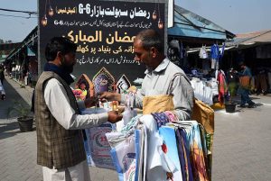 A customer purchases shopping bags before buying groceries at the Ramazan Sahulat Bazaar in G-6, where essential commodities are being provided to citizens at subsidized rates in the federal capital.