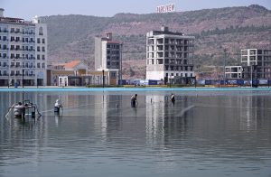 Labourers carry iron rods for the construction of a building at Park View City in the Federal Capital.