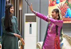 A student performs on stage during the Singing Competition (Folk & Ghazal) at Islamabad Model College for Girls (PG), G-10/4.