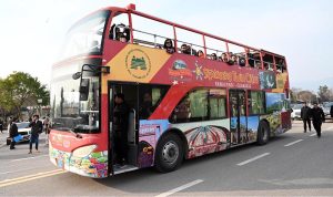 Visitors enjoy a double-decker bus ride during the two-day Pakistan Tourism, Sports & Family Festival at the Sports Complex in the Federal Capital