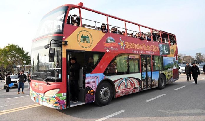 Visitors enjoy a double-decker bus ride during the two-day Pakistan Tourism, Sports & Family Festival at the Sports Complex in the Federal Capital