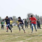 Students participate in the 100-meter race during the opening ceremony of the 'Reade Sports & Cultural Wave' event at the Tehsil Sports Complex