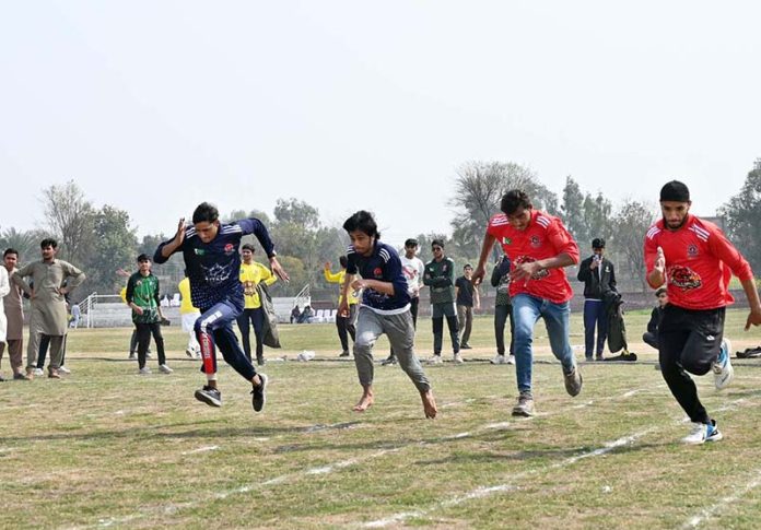 Students participate in the 100-meter race during the opening ceremony of the 'Reade Sports & Cultural Wave' event at the Tehsil Sports Complex