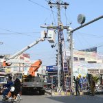 WAPDA workers busy in repairing electric wires on pole during maintenance work at Nawan Shehr.