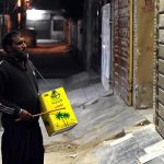 A drum beater walks through a residential area, beating his iron drum to wake people for Sehri during the holy fasting month of Ramazan-ul-Mubarak