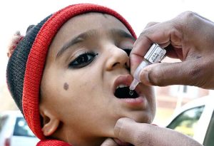 A health worker administers polio vaccine drops to a child during an anti-polio campaign at DHQ Hospital.